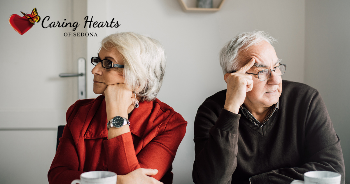 A senior husband and wife are sitting down, mad at each other, representing some of the difficult family dynamics you may come across as a professional caregiver.