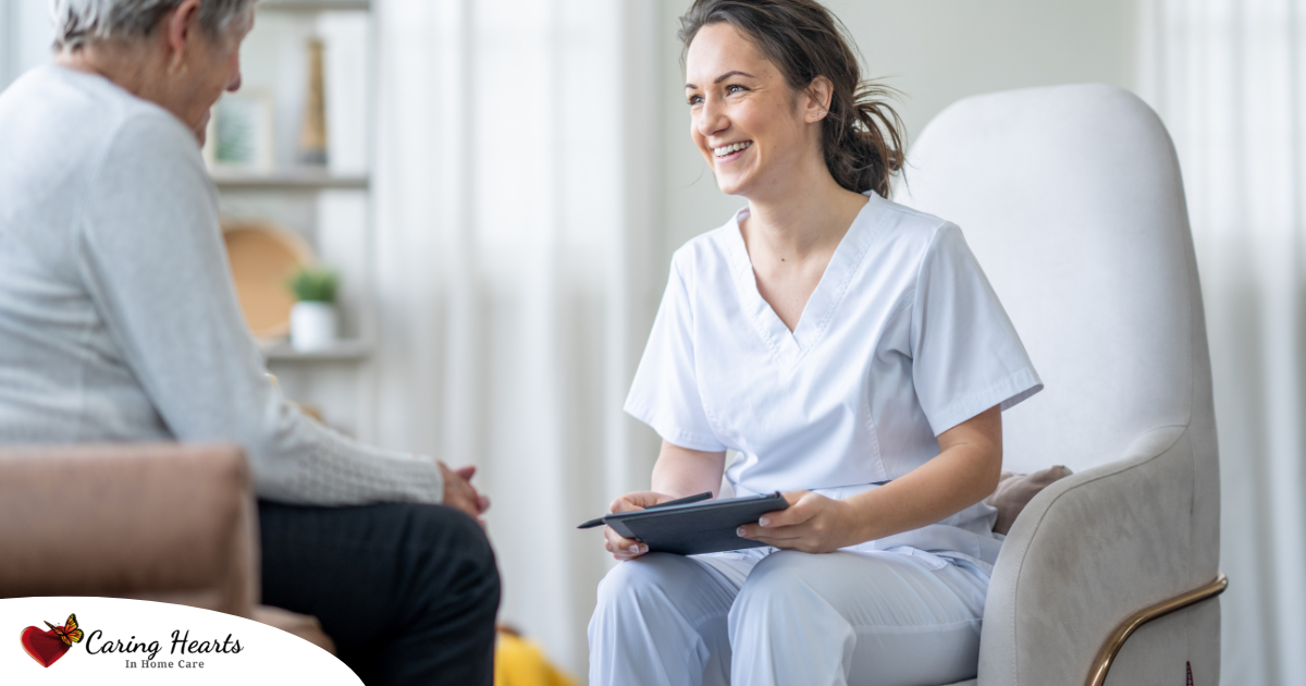 A woman smiles and enjoys her caregiving job as she writes notes down with a client.