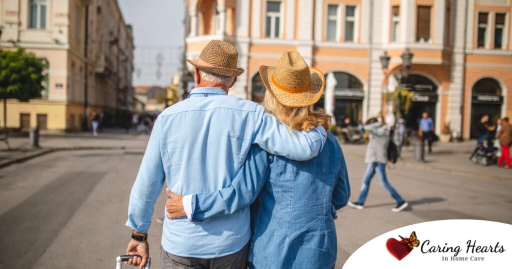2 older adults hug while on vacation representing the successful outing that can still happen while caring for elderly loved ones.