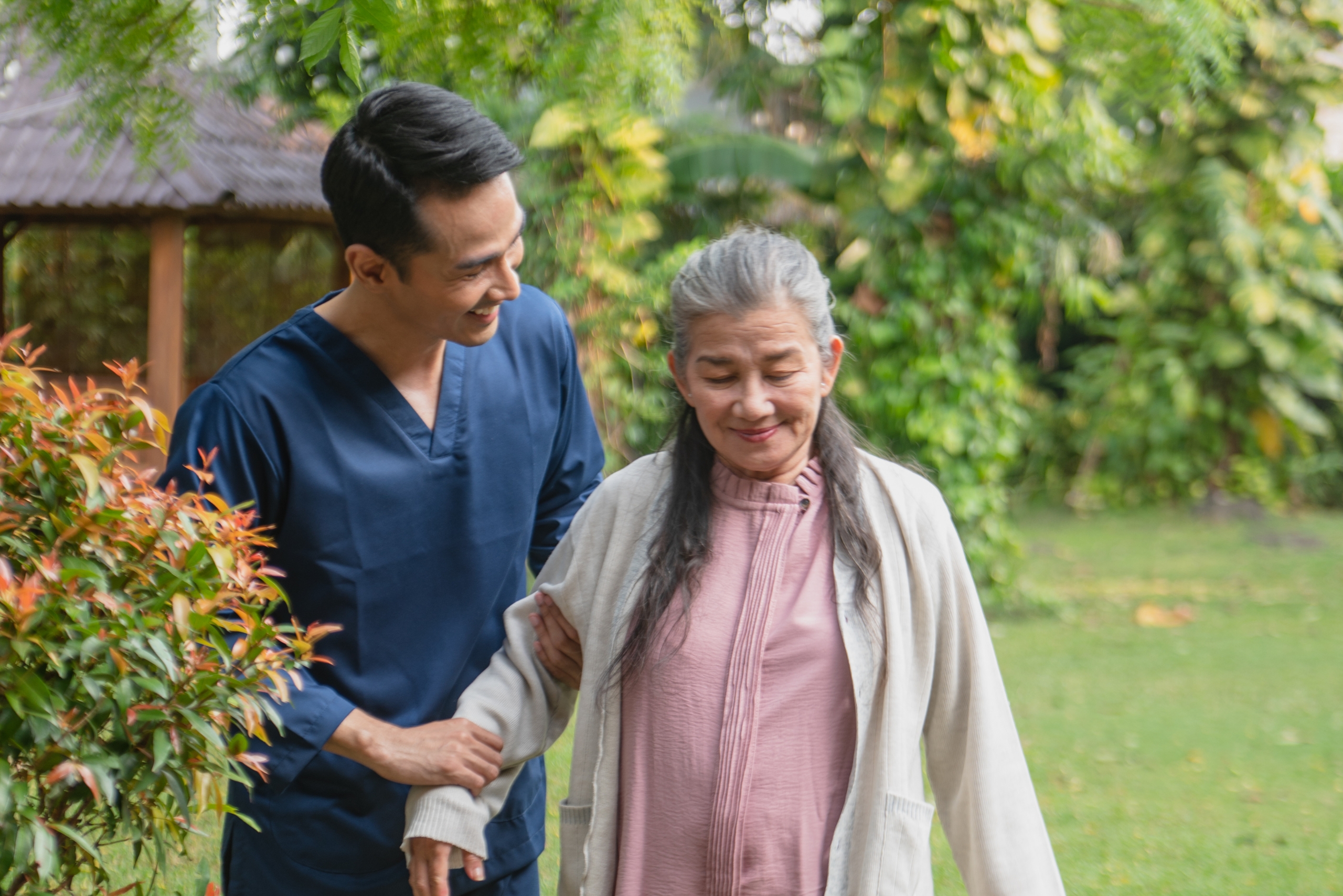 Caregiver providing walking assistance to a senior outdoors during Live-In and 24-Hour Care in Sedona, AZ.