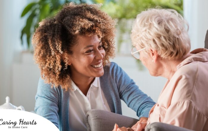 A caregiver warmly speaks with an older client, representing the quality communication that can come with bilingual care.