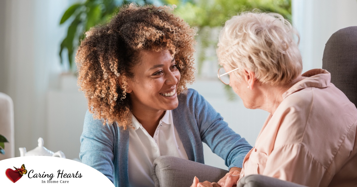 A caregiver warmly speaks with an older client, representing the quality communication that can come with bilingual care.