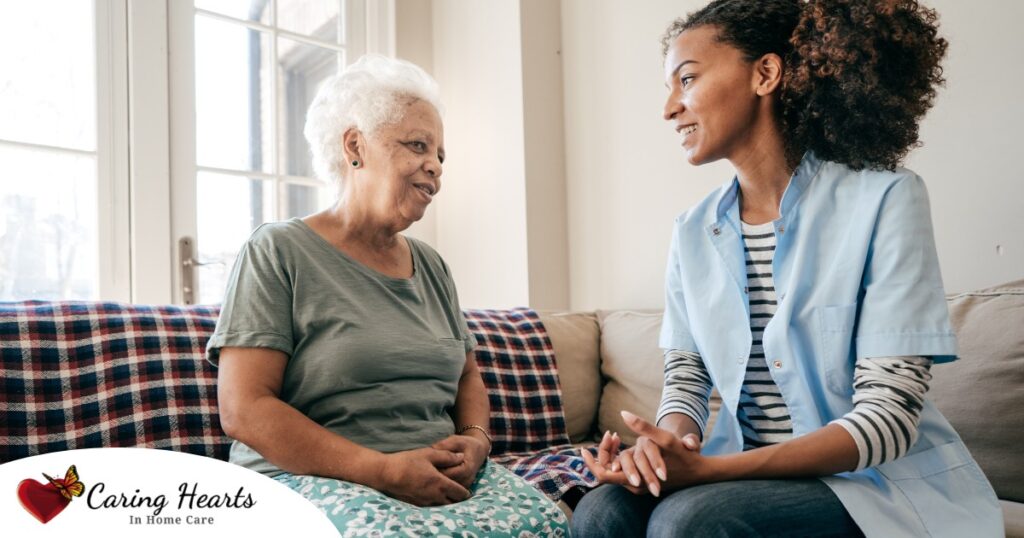 A caregiver sits and spends time with a client, representing how non-medical home care can benefit older loved ones.