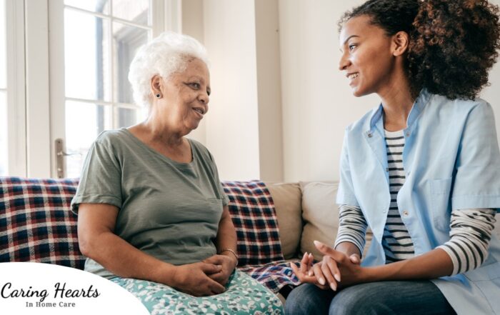 A caregiver sits and spends time with a client, representing how non-medical home care can benefit older loved ones.