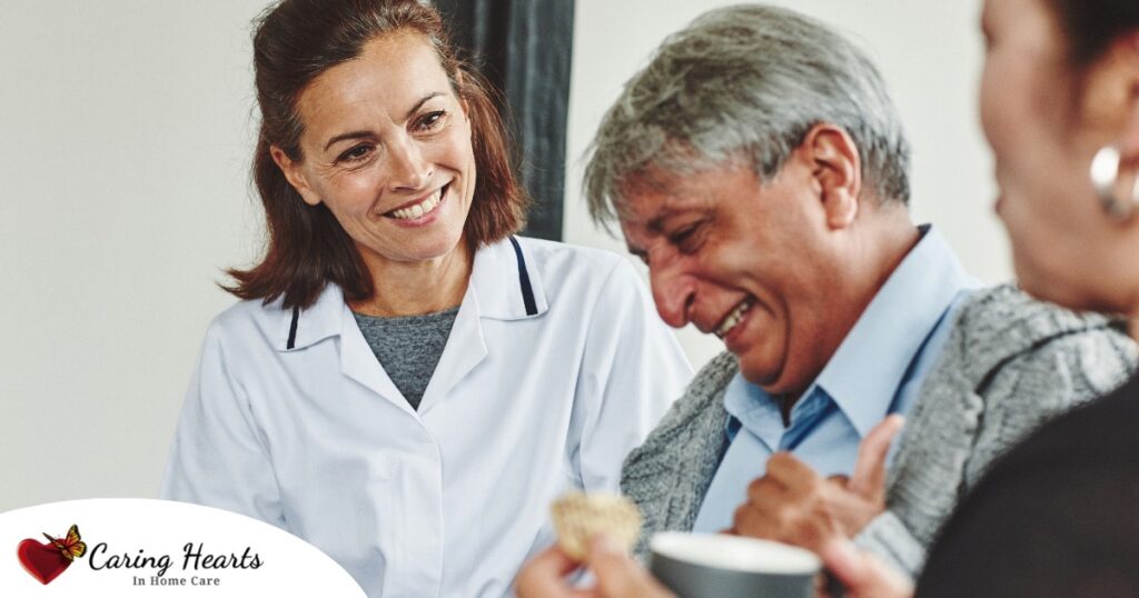 A woman smiles while with clients showing how you can enjoy senior caregiver jobs.