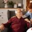 A caregiver helping a woman with a walker make her senior home safer.
