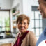 Caregiver provides attentive senior care as part of diabetes awareness