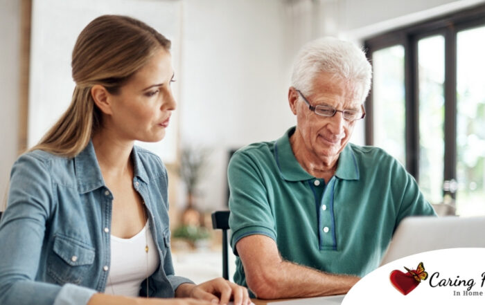 Adult daughter and senior father talking at a kitchen table while comparing home care vs assisted living